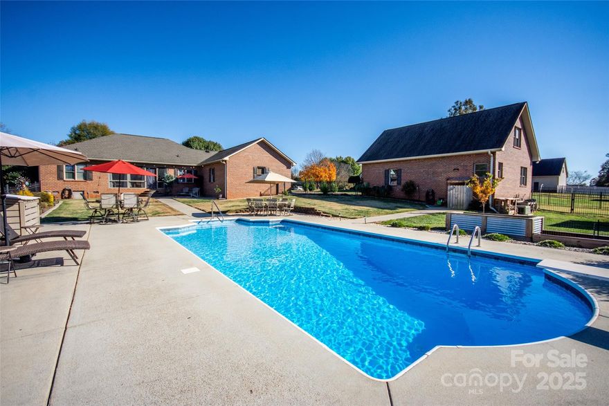 PRICE IMPROVEMENT!  Seller is highly motivated, all offers are welcomed and encouraged!  This stunning all brick, 3 bedroom, 2.5 bath home offers the perfect blend of modern updates, functional design, and outdoor living. Remodeled throughout, this entertainer’s paradise features luxury vinyl plank flooring, neutral paint, a beautifully tiled backsplash with granite countertops in kitchen, and an upgraded primary bathroom. Each bedroom includes custom built in closet systems, maximizing space and organization. Secondary bedroom currently used as an office but could easily be converted back into a bedroom!

The split floor plan allows for privacy and easy one level living, ideal for families and guests. Step outside and you’ll find everything you need for year round enjoyment, a inground pool, outdoor shower, fire pit, raised garden beds and patio area perfect for entertaining or relaxing.

A detached 2 car garage features a full in-law suite complete with its own kitchen and living room, providing a great option for guests, extended family, or a private workspace. There’s also an additional room ideal for crafting, baking, or hobbies in the lower level of the detached garage. With a total of 4 garage spaces, you’ll have plenty of room for vehicles, tools, and toys.

An insulated 10x20 outbuilding with its own mini-split system for heating and cooling offers even more storage or workspace flexibility.

This home is truly move in ready and checks all the boxes, comfort, style, and convenience! Located just minutes from shopping, dining, and amenities, and within 45 minutes to Winston-Salem or Charlotte, you’ll love the balance of peaceful living and accessibility.

Property is listed as a 4 Bedroom.  Iredell County does not have record of septic on file for the home but does have record for detached garage.

This home will not disappoint, schedule your private showing today!