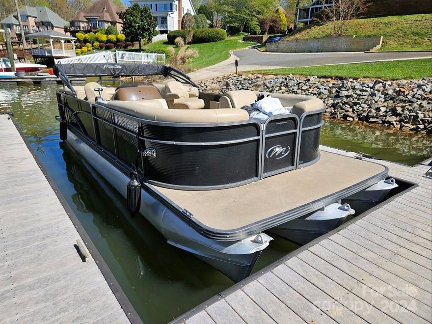 This home is currently being rented as a Vacation Rental until Sept. 1st.  It is Conveniently located next to club house & pool. Walk through the back yard which leads directly to the deeded boat slip.  Spacious primary bedroom located on the main level and has a completely renovated primary en suite, enormous walk- in closet and sitting area. Living room offers a gas fireplace with an open area concept leading into the kitchen and breakfast area.  Kitchen has also been completely renovated with plenty of storage.  Just off the kitchen, a large sprawling screened in deck awaits you where you can enjoy a stunning view of the lake.  New waterproof luxury vinyl flooring has recently been installed in the basement where you will also find a full kitchen, large bedroom with en suite bathroom, Billiard and Exercise Room.