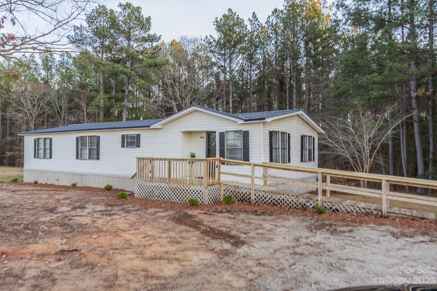 Quiet ,serene, country living describes this Buford property just waiting for you to call it HOME. Three bed, two bath manufactured home with 1419 sq. ft. and sits on just under an acre of land. The home has been refreshed with many beautiful upgrades to include new metal roof, paint, flooring, rear deck, countertops, kitchen cabinets, HVAC and moisture barrier. Enjoy Spring, Summer and Fall evenings on the front deck. Don't miss out on this Buford property. Call today for your private showing.