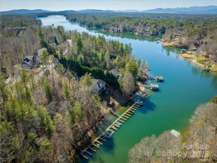 RARE FIND... 1.44-ACRE NICELY LAID-OUT LOT ON LAKE JAMES WITH DEEDED BOAT SLIP!! This lot offers a gentle slope with beautiful mature trees and an already cleared building area. Even better, it's located very close to the cul-de-sac and the lot’s deeded boat slip. The #2 boat slip (Phase 6) is a deep-water slip at the end, offering easy docking and open water views. Enjoy all Lake James has to offer—Blue Ridge Mountain views, sandy dockable beaches and islands, great fishing, and a mecca of other outdoor activities. This community is located less than 15 minutes from Downtown Morganton and 45 minutes from Asheville. Community amenities include a pool, clubhouse, tennis court, and streetlights. Build with ease—the seller has already completed a survey and septic perc for 4 BEDROOMS. This road is also state-maintained! Travel to the end of Harbor View Terrace, and you will see the parking area across from the community slips... slips are numbered.