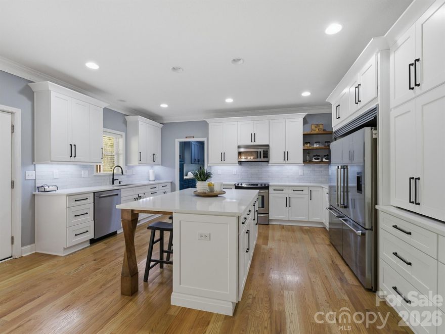 Welcome home to this beautifully maintained and thoughtfully updated property that’s ready for you to move right in and enjoy. The heart of the home is the stunning, fully renovated kitchen featuring quartz countertops, a stylish tile backsplash, and custom-built cabinets that include handy outlets for your small appliances. With extra-tall cabinets, pull-out drawers, and a commercial refrigerator and freezer, this kitchen is perfect for everyday cooking and family gatherings. The spacious laundry room offers a butcher block countertop and plenty of cabinets to help keep everything organized and tidy.

You’ll love the three-car garage setup, with one detached bay that’s been turned into an amazing workshop space. It has epoxy flooring, a sink, a wood stove, and lots of outlets for all your tools—great for DIY projects, hobbies, or just tinkering around.

The backyard is made for relaxing and spending time with family and friends. It’s fully fenced, with wood fencing on the front and sides for privacy and chain link along the back so you can still enjoy the view. There’s an above-ground pool with a big patio for lounging and a walkway that leads to the screened-in porch, where you can sit and enjoy a quiet morning coffee or a peaceful evening. The front porch has outlets in the ceiling for hanging lights, and there’s also a deck off the screened-in porch—perfect for outdoor dining or fall evenings by the fire pit.

Inside, you’ll find new hardwood floors throughout the main level and a bright, freshly painted primary bedroom suite. The ensuite bathroom includes a walk-in shower with a rain shower head, a relaxing garden tub, and custom-built cabinets for extra storage. The home also features a whole-house water filtration system, a fully encapsulated crawl space by Dry-Pro, and newer windows across the front for better efficiency and comfort.

Upstairs offers even more space, with a large bedroom, a kitchenette, and a roomy recreation area that can be used in so many ways—perfect for guests, an older child, or even a private suite for extended family.

From top to bottom, this home has been cared for with attention to detail and pride of ownership. It combines modern updates with practical features that make everyday living easy and enjoyable. Conveniently located just minutes from the highway, this property offers the best of both worlds—quiet, comfortable living with quick access to shopping, schools, and everything you need.