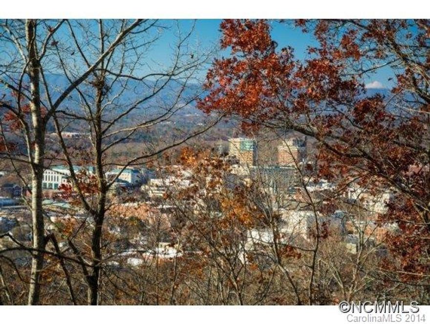 BAck up offers accepted! Location! Just minutes from downtown Asheville! City Water and City Sewer! Peaceful wooded lot with Beautiful Sunset Views of Downtown Asheville and mountains! Build your dream home with the advantages of both close proximity to "everything" and private mountain, wooded location. Land has a path/trail cleared for easy walking. Entry by for sale sign.