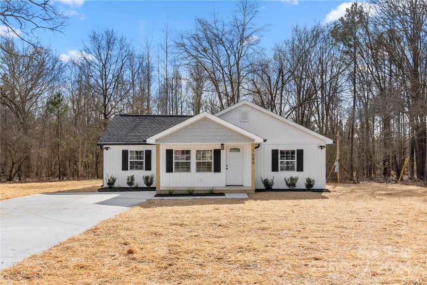 Are you longing for a new home in a country setting? With 1.802 acres close to Lancaster and Heath Springs, this freshly renovated and move-in ready 3 bedroom, 2.5 bath ranch home offers an open floorplan  with a large kitchen with island and plenty of storage and work space. Split bedroom plan with central hall. Owners suite features dual vanities and walk-in closet. Two more bedrooms with full bath. Powder room, drop zone, and laundry. This home features a covered front porch deck and large rear deck perfect for entertaining! Mature trees. A new heat pump, new plumbing and electrical, soft close cabinets with stone countertops, ceiling fans, engineered flooring and neutral paint throughout and much more. No HOA. This is the one you have been searching for!