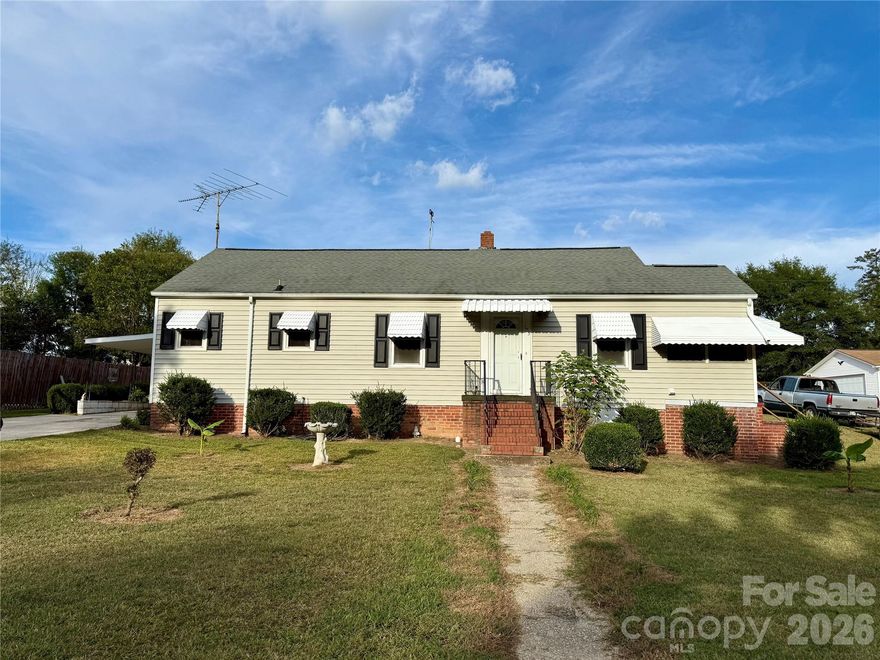 Charming 1960's single-story home featuring 2 bedrooms, 2 baths, and an attached carport on an easy .35 acre lot. Nestled in a quiet, well established neighborhood, this mid century charmer offers bright living spaces, classic character, and plenty of room. The home offers both formal and informal dining and living spaces. There appears to be hardwood floors under the carpets. The kitchen features a cute, retro style with a built in corner booth. There is also a detached garage/ workshop in back and a convenient paved drive.