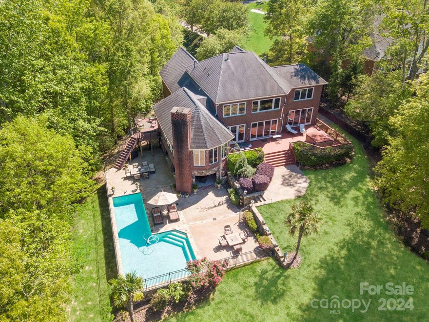 Owners says get it SOLD!   Huge price reduction, $450,000 below recent appraisal. Full brick 4 bedroom home with views of big water, saltwater pool, with covered dock and boat lifts.  Amazing views of open water, with lake views from family room, primary bedroom and sunroom.  Stroll out the back door onto the deck with hot tub, or wander down to the pool to enjoy a dip on a summer day. This home has been designed for a relaxing lifestyle at the lake.  Open floor plan with primary suite on main, dining room and family room opening to rear deck with hot tub.  Chef's kitchen with stainless steel appliances and Viking gas range, custom cabinetry and granite countertops.  Oversized 2 car garage with ample driveway parking. Upstairs features bedrooms, office with closet and 2 full baths, bonus room walk-in unfinished areas for storage. Pool area features a covered Lanai with outdoor kitchen, granite bar, full bathroom and gas log fireplace.  Home will only be available until November 10th.