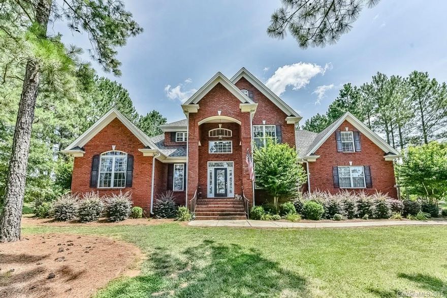 Remarkable FULL BRICK home with great living space. Two-story Foyer and Great Room with open floor plan. Hardwood floors on main level, except in the two bedrooms. Kitchen has solid surface counter tops, back splash, double wall ovens and microwave/convection oven.  New gas cooktop with downdraft exhaust, new refrigerator. Pull out shelving in base cabinets and under counter lights.  Invisible fencing - double set for cat and dog.  MBR and 2nd bedroom with bath on the main level.