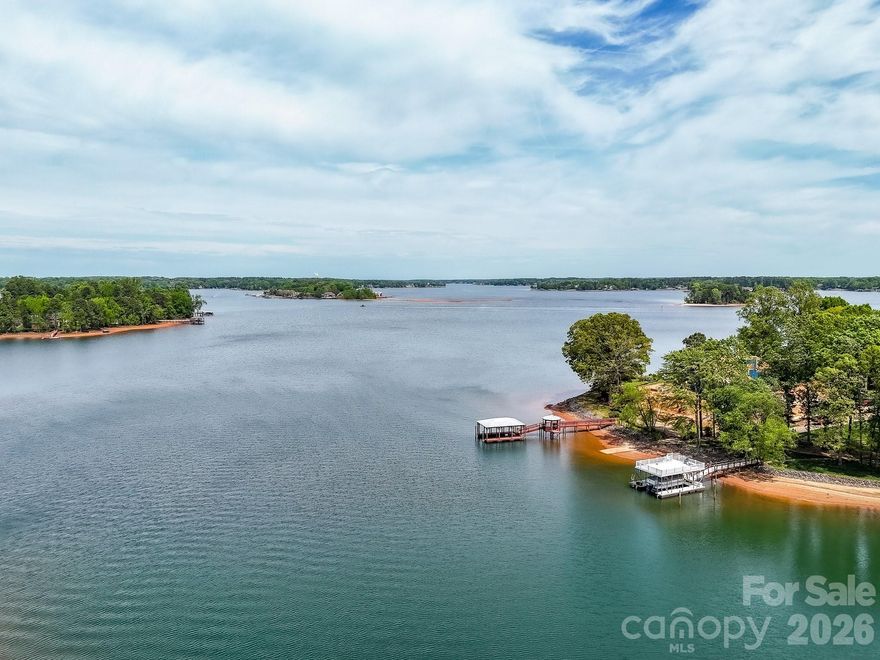 Rare opportunity to own a private Waterfront Retreat in one of Denver’s most sought-after locations. Set on an exceptional ¾-acre lot with over 170 feet of shoreline, this property offers an expansive Dock footprint featuring Two Boat Slips, a Floating Dock, and a Covered Gazebo—perfect for relaxing and taking in the serene lake views. Ideally positioned at the widemouth of a quiet cove, you’ll enjoy the best of both worlds: calm, protected waters for swimming and privacy, along with quick, easy access to the main channel. Whether you’re looking to build your dream home or renovate the existing residence, the possibilities here are outstanding. Designed for entertaining, the home features a spacious Deck with year-round water views and a dramatic Great Room with vaulted ceilings, a masonry fireplace, and excellent potential to open into the Kitchen for modern living. The upper level offers two Bedrooms, each with Private Baths, hardwood floors, and abundant natural light. The lower level provides flexible living space with updated flooring, a large Bedroom or Secondary Living Area with its own masonry fireplace and walk-in closet, plus am additional Bedroom with sliding glass doors that open to a Lakeside Patio—bringing the outdoors in. Located just minutes from popular dining, breweries, and everyday conveniences, including Lake Norman favorites like Lake Norman Brewery and The Foundry, this home combines peaceful waterfront living with easy access to everything the area has to offer.
Note: Exterior deck and dock require TLC. Please use caution when touring. Access is limited to the fixed portion of the dock—do not walk on floating dock, slips, or ramp.