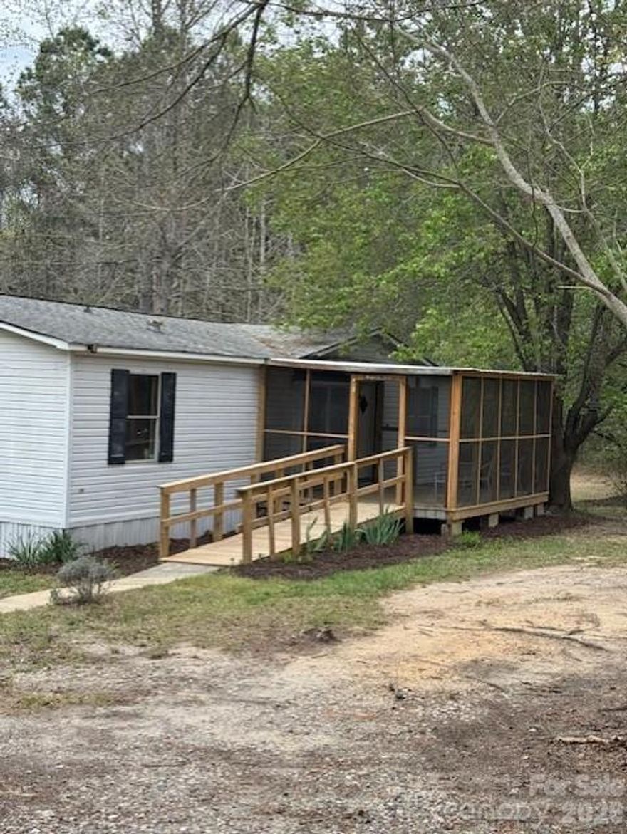 8 Acres of Beautiful hardwoods encircle this sweet home waiting on a new owner to add their special touches.  Build your dream home, add to your rental portfolio or just enjoy life on the oversized back deck or morning coffee on the screened porch. There are two wells and two septic tanks on this property. Bring your dreams and let your imagination take you away.