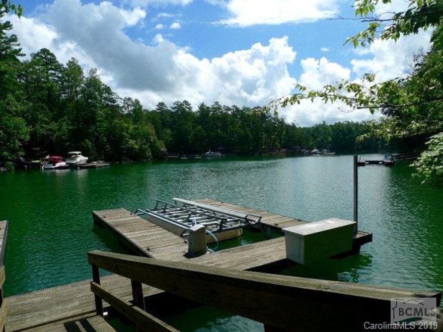 4.5 acre fully wooded waterfront lot with cleared building area close to lake and nice walk to water.  Aluminum  frame 2 slip dock with lift already in place in private & quiet deep water cove.  Enjoy the lake in this private lot with building site close to water and not visible from the road.  $15,000 credit at closing for new dock decking.  Perced for 4 bedroom home with city water.  Dry Creek walking trails and parks along with Southpointe pool and clubhouse amenities included in low HOA dues.   15 minutes to Morganton stores and restaurants. Custom home plans for the property available in attached documents.