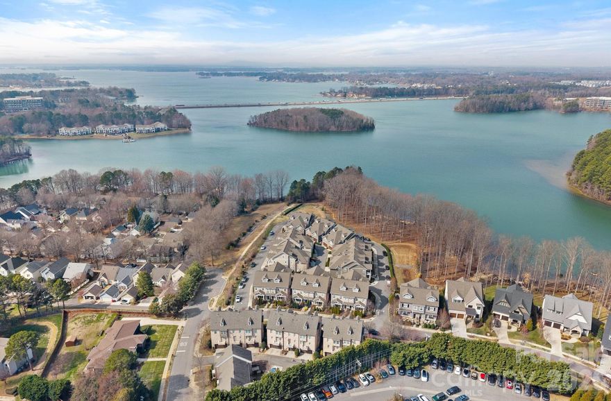 Welcome to one of the most well known townhome communities in the Lake Norman area. Davidson Bay consists of a variety of townhomes and single family homes. 744 Amalfi is part of a prestigious 20 home grouping with private lakefront access and dedicated kayak storage. This luxurious townhome includes lots of sqft, upgrades and open spaces. Key advantage is all 3 stories are serviced by an Elevator providing easy access when needed. Being an End Unit tons of natural light flow in the home and accentuate the soaring ceiling height. Main level welcomes you with a cozy living room with gas log fireplace, open to casual Dining area and ending in the Gourmet Kitchen. The Island is large enough for additional seating and storage. Abundant cabinetry and gourmet SS appliances, like the Italian Bertazzoni 5 Burner Range and Hood. Pantry has double glass doors and custom shelving. Drop Zone and the 1/2 bath are near the rear entry by the 2 car attached Garage. Don't miss the garage storage and epoxy floor. Entertaining friends and family easily flows from indoors to outdoors with the large sliding doors to the beautiful courtyard style terrace. Middle level has 2 guest Bedrooms each with Ensuite Baths featuring Quartz countertops and the Primary Bedroom located privately in the rear of the home. Primary includes built in shelving and a custom designed Closet. Spa Bathroom offers dual sinks and Quartz countertop, soaking tub and separate shower which will melt away all your stress. End the day on the private screened in balcony. Laundry room is also on the middle level for ease of use. Top level is open to staircase so works well for a studio or office although it can serve as a 4th Bedroom with another Ensuite Bath, Custom Closet and Storage. Plantation shutters throughout.
Community has kayak storage and Lake Davidson access. Short distance to Downtown Davidson, local restaurants and grocery.