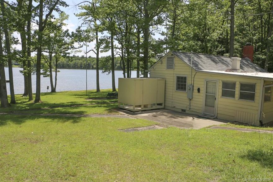 Level waterfront property on 1.2 acres with a huge open view! Existing cabin has a large screened porch - - enjoy as a summer retreat until you're ready to build. Cabin has been beautifully maintained by the original owners, very clean.  Terrific area on Allison Creek channel of Lake Wylie, in the excellent Clover school district. Lots this level are hard to find!  Excellent opportunity to enjoy now, build when you're ready.  See tour!  Property also listed as MLS #3148609 as Land.