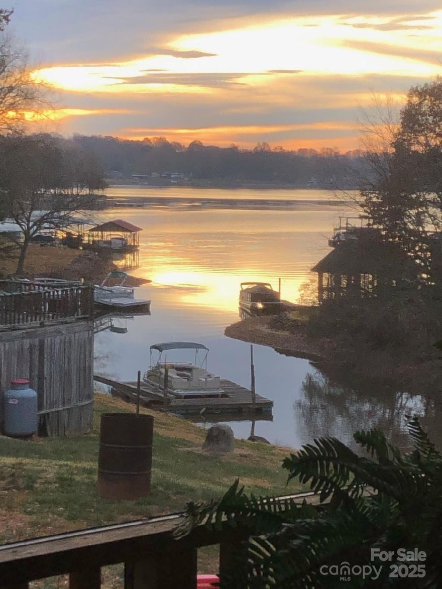 Enjoy this waterfront maintenance free, brick ranch home with a stunning view, year round of the lake.  Home is located in a very popular neighborhood in Mooresville with no HOA dues.  Quality built custom home by local builder on large lot to park that RV, Boat, and or extra vehicle.  Close to restaurants, shopping, activities ongoing in Mooresville.  Floating dock to enjoy small watercraft.  No disclosure on floating dock, no permit, sold as is.  Two storage buildings. Sit on the large tiled screened porch and enjoy the beautiful views of Lake Norman.  Home being sold furnished.  Improvements to the home include, new roof in 2018, updated HVAC system and duct work in 2018, new hardwood floors installed in 2018.  Home has a wooden privacy fence on each side giving you a private setting from neighbors.  Backup Offers Being Accepted !!