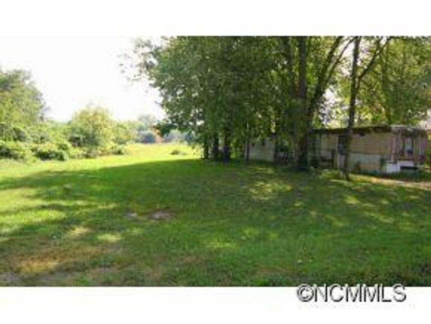 Unique chance to own 2+ level unrestricted acres in Hendersonville ETJ - Zoned R-15 medium density w/ paved state road frontage. Existing manufactured home w/ pastoral views. Suitable for subdivision, duplex, multi-family, or farming, agriculture, horses, etc. Home needs some work but could provide temporary home while you build; could remain for rental income. One of the few remaining multi-acre parcels this close to town.-