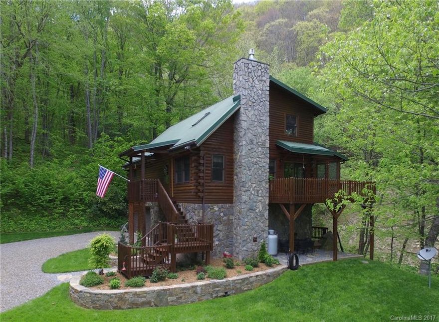 Immerse yourself in the sights and sounds of the mountains at this completely updated and perfectly maintained log home.  Three levels of decks, perfect for entertaining, allow the music of a roaring creek to perforate the home. Updates include custom cabinetry and granite tops, flooring, appliances, fixtures, log refinishing and paint.  A convenient utility lift takes the work out of transporting items to the main level.  Gorgeous perennial beds frame the mountain view.  A showstopper cabin.