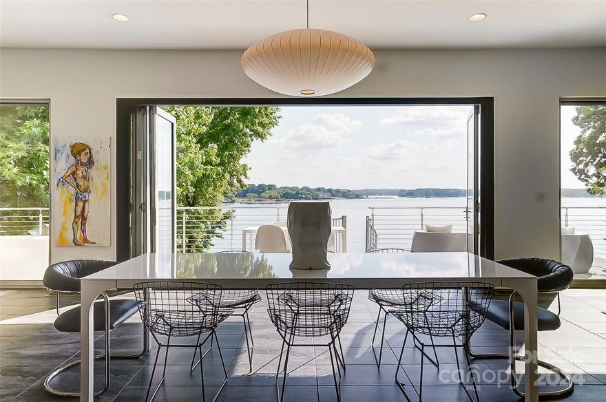 LAKEFRONT LUXURY on the main channel where East Coast meets West Coast! Experience luxury lakefront living in this 4400 square foot custom-design home, offering 126 feet of shoreline and breathtaking main channel views of Lake Wylie. Step into the main floor open living concept space featuring a 15-foot accordion door leading onto a spacious balcony, seamlessly blending the indoors and outdoors. Kitchen features a quartz waterfall island, 3-D tile, glossy white cabinetry, and a full size walk-in pantry. Luxurious baths to include 3 full, including a steam shower, a powder room, and an outdoor shower for a spa-like experience at home. Additional outdoor living with a lounging area, private, saltwater, heated pool with infinity water views. Close to I-77, 20 miles south of Uptown Charlotte, and Fort Mill Schools! This property is the perfect blend of East Coast elegance and West Coast modernity, creating a unique and inviting space for luxurious living and entertaining.