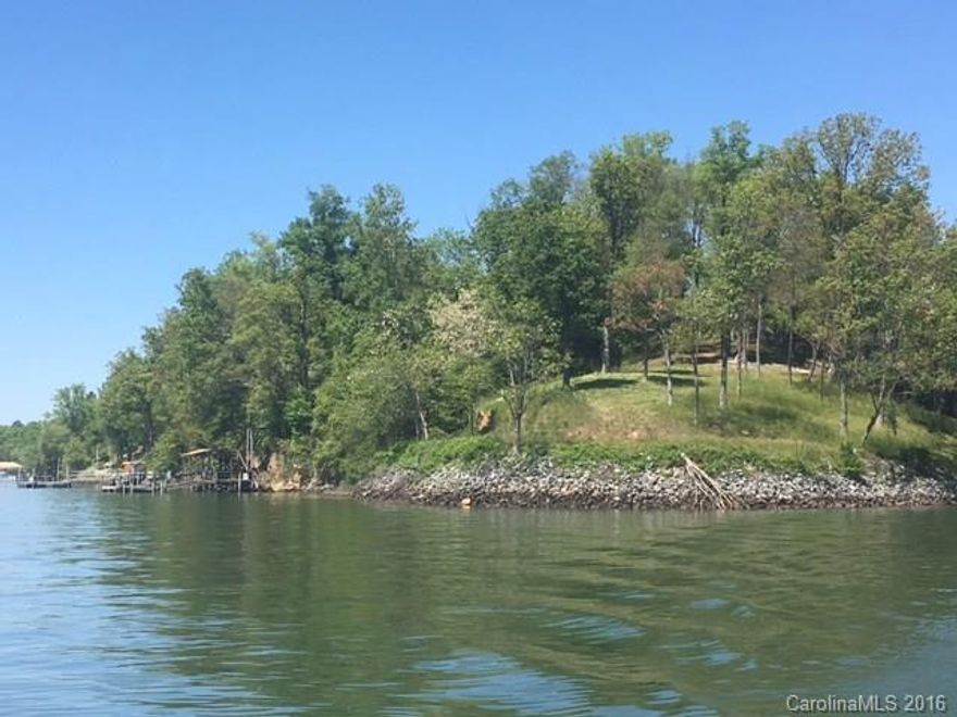 Magnificent peninsula waterfront, main channel lot, w/year round expansive sunset views! Build your dream home on this .67 acre, deep water, gently-sloping lot. Park-like setting w/ great privacy surrounded by high-end waterfront homes in exclusive Windjammer Park section of Tega Cay! Public utilities & paved road. At the end of a cul-de-sac, with no thru- traffic in a very quiet, serene setting. Dock pilings in place to build your custom dock. Shoreline work completed! FM schools!