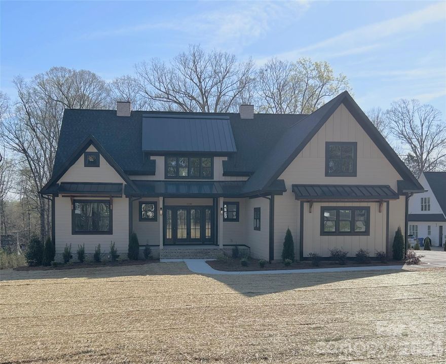 You'll be impressed upon entering this quality built, spectacular home with all the "Bells and Whistles", flooded with natural light, just minutes from Lake Norman with room for a pool! Prepare to fall in love with this stunning, well-appointed new construction home that combines modern elegance, timeless craftsmanship and the ultimate in functionality. Ideally located just minutes from Lake Norman, you’ll enjoy all the lifestyle perks of lake living, boating, fishing, waterfront dining & endless recreation, while still being conveniently close to schools, shopping, medical facilities and restaurants. This exceptional home offers the perfect balance of luxury and everyday comfort. Sitting on a level 0.69-acre lot with room for a pool, pool house or detached single car garage and no HOA, this gorgeous home with an open floor plan boasts 3,672 square feet of living space, flooded with natural light, beautiful finishes, impressive trim work, two laundry rooms, zero entry showers and primary on the main! From the moment you step inside, you’ll notice the meticulous details that set this home apart: crown molding, wainscoting, engineered hardwood floors, oak stair treads, extensive trim work, coffee/ bar with mini fridge area, nook wine shelves, built-in desks/bookcases, striking black-and-white windows & stylish tile backsplashes that give each space a distinctive touch. The chef’s kitchen is nothing short of spectacular. Designed for those who love to cook & entertain, featuring floor-to-ceiling cabinetry, 48inch natural GAS range with double oven, under cabinet lighting, oversized island with storage and a beautifully appointed scullery with a second dishwasher, microwave, tons of cabinets & ample space for everything you need. This kitchen is as functional as it is beautiful, offering plenty of prep space and seamless flow into the dining area and family room. The family room is a true showpiece, highlighted by a gorgeous fluted vertical tile fireplace wall with built-ins, floating shelves & custom mantle. A wall of windows allows natural light to flood the space while showcasing views of the backyard. With its open layout & thoughtful design, this is the perfect spot for relaxing evenings at home or gatherings with family and friends. The main floor primary suite offers a private retreat and spa-like bath complete with a zero entry shower, freestanding tub and spacious walk-in closet w/custom shelving. Also on the main level, you’ll find an office/flex room, ideal for working from home or hobbies, a laundry room with sink & cabinetry, drop zone and full bath. Upstairs you'll find 3 spacious bedrooms, 2 are connected by a thoughtfully designed Jack-and-Jill bathroom, where each bedroom enjoys its own private vanity & toilet, with a shared tiled tub/shower between. The 3rd bedroom has access to a beautiful bath with a tiled walk-in shower. A loft area with built-in desks, floating shelves & cabinetry provides an ideal space for study, TV watching or game playing, while a large bonus room offers even more flexibility for a playroom, media room or workout space and attic storage. A second laundry room adds convenience & practicality for busy households. Outdoor living is just as impressive as the interior. Step out to a covered back porch with a beautifully stained ceiling and two ceiling fans, perfect for enjoying the outdoors in comfort year-round. With nearly three-quarters of an acre, you’ll have plenty of room for outdoor activities, gardens or a future pool. The side load finished garage has been pre-wired for electric vehicle charging. Home also includes a natural gas tank-less hot water tank. Located in a highly desirable area just minutes from Lake Norman, this home offers the opportunity to enjoy the ultimate lifestyle—close to the water, in a quiet setting on a dead end street. With easy access to schools, shopping, restaurants, medical facilities & major highways, the location is as convenient as it is beautiful.