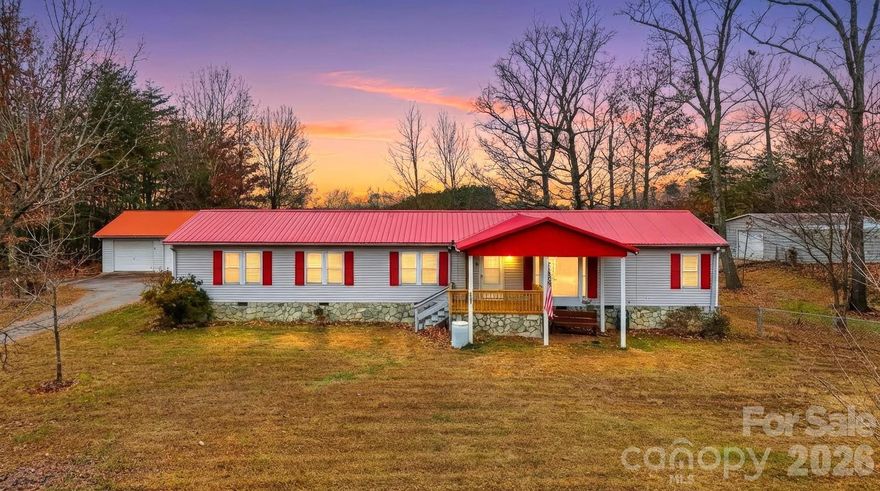 Calling all hobbyists, homesteaders, woodworkers, car enthusiasts, gardeners, and anyone dreaming of peaceful acreage with room to breathe—this property offers endless possibilities. Set on 3.64 quiet, usable acres beside a tranquil tree farm, this 4-bedroom on-frame modular home invites you to live, work, and unwind in a setting that feels worlds away yet remains conveniently located. New central air/heat pump and Hot water heater all replaced 2025. 

Step inside to a spacious open floor plan designed for connection, with wood plank and tile flooring throughout and a comfortable split-bedroom layout that places the primary suite on one side of the home and the additional bedrooms on the other. The living, dining, and kitchen areas flow together easily, creating a warm central hub for gatherings, daily routines, or cozy evenings in. Natural light filters through the home, adding to the sense of calm and simplicity.

One of the most beloved features is the large covered back porch, stretching almost the full length of the home. Picture slow mornings with coffee, afternoons listening to the breeze move through the trees, or evenings unwinding as the sun sets across your acreage. It’s a space that truly expands the heart of the home outdoors.

For anyone who creates, builds, tinkers, or dreams big, the outbuildings deliver exceptional value—each equipped with electricity to support a wide range of uses:

An 1100-sq-ft detached 3-car garage, perfect for vehicles, tools, equipment, a workshop, or storage.

A dedicated woodworking shed, ideal for crafting, projects, or hobby space.

A metal barn with a history as a three-stall setup with a tack room, now used for storage but easily adaptable for animals, gardening supplies, or outdoor equipment.

A two-car metal carport offering additional covered parking or gear protection.

The land itself is a blank canvas—quiet, mostly open, and ready for gardens, small livestock, recreation, or simply enjoying the rhythm of country living. Whether you envision raised beds overflowing with vegetables, a small flock wandering the pasture, or a workshop where your creativity takes shape, the property welcomes it all.

If you're seeking a peaceful retreat with versatile spaces and room to grow your lifestyle in any direction, this property offers a rare combination of comfort, functionality, and natural beauty.