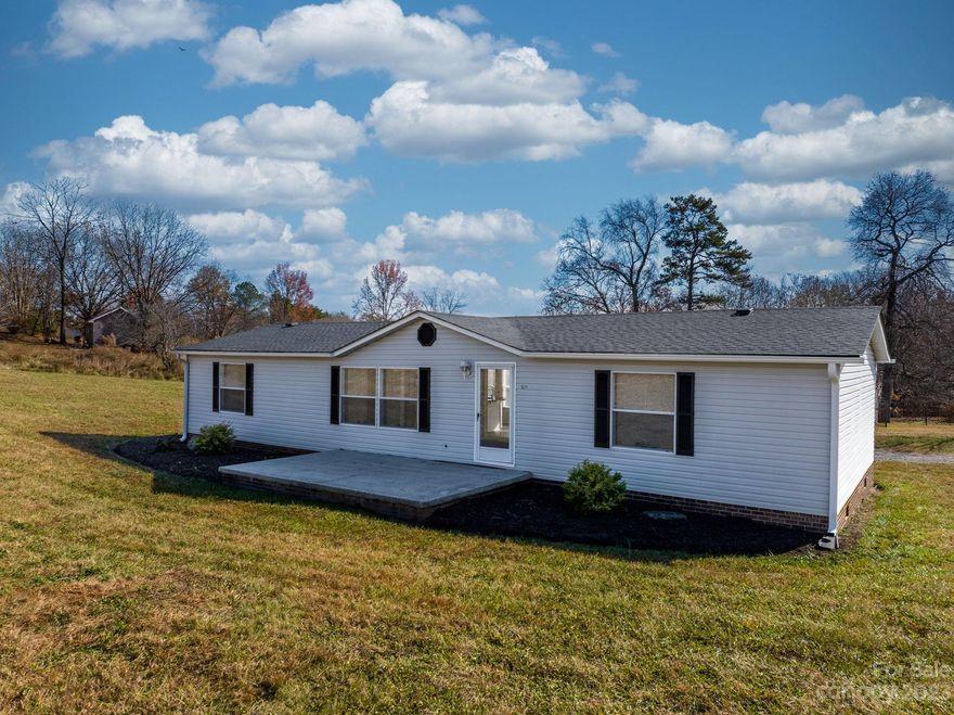 FRESHLY UPDATED 3BD 2BA Doublewide on a 1.04 acre lot! Wonderful split bedroom plan. Primary bedroom w/ ensuite bath, garden tub, stand up shower and walk in closet. Spacious kitchen w/ all appliances, plenty of cabinets and dining area w/ lots of windows that provide natural light. Living room w/vaulted ceilings and two additional bedrooms w/ walk in closets. Hall bath and laundry room !!! Fresh paint, all new flooring & new floor vents through out! HVAC unit is approx. 4 years old, architectural shingle roof installed 2 years ago and new hot water heater. This home sits on a beautiful lot in a very sought after school district...minutes to schools!! Less than a half mile to McGalliard Falls Park. Permanent brick foundation, front cement patio PLUS 2 large back cement patios. Carport & enclosed garage for parking. Outbuilding w/ separate power & water on a concrete slab.(in need of repair.. could be torn down and new building erected.) MOVE IN READY $199,000