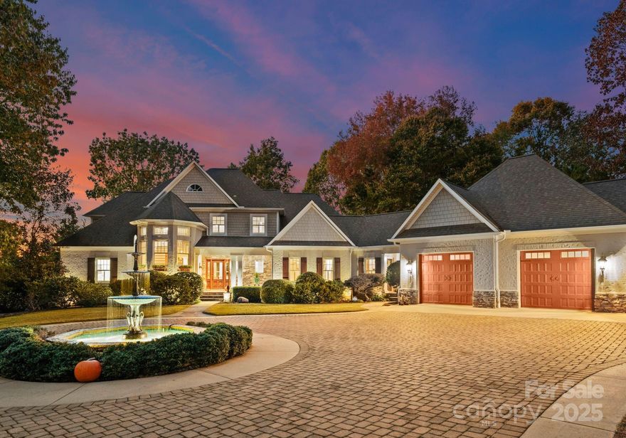 A hidden gem on Lake Norman! Tucked away & nestled among mature trees, this stunning estate is the epitome of privacy, serenity & refined lakeside living. The elegant circular drive, glowing fountain & beautifully manicured landscaping welcome you into a world of calm sophistication. Crafted w/timeless architecture & exquisite attention to detail, the home offers expansive living spaces bathed in natural light, sweeping views of the lake & surrounding woodlands. Step out onto the elevated stone terrace & experience a breathtaking panorama—perfect for sunset dining or peaceful mornings w/coffee in hand. The backyard is a true sanctuary. Meandering garden paths lead to a cozy fire pit & covered dock ideal for boating, fishing or simply soaking in the quiet magic of the water. This one-of-a-kind property seamlessly combines luxury w/nature, offering a secluded lifestyle just minutes from the best of LKN. Botanical, peaceful & impeccably designed—this is more than a home, it’s a retreat.