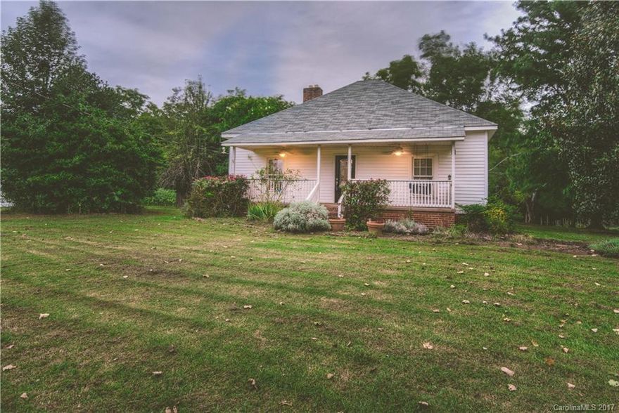 Charming Fort Mill home awaiting your personal touch! Rare find sitting on +/-1 acre. This property is adjacent to the 2100 Acre Anne Springs Greenway. Walk to Lake Haigler from your backyard. Updated kitchen with center island, 10 foot ceilings on main floor, wood burning fireplace on main floor. Sitting porch both front and back with balcony off of upstairs master overlooking the Greenway. City water and sewer along with well on the property for the yard. Newer roof and HVAC. No HOA!