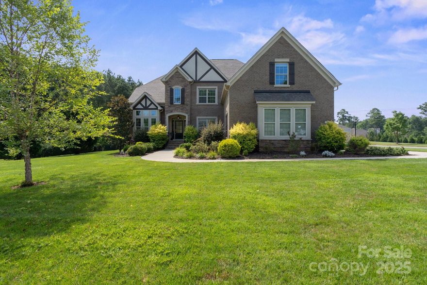 Nestled in a desirable Union County neighborhood w/mature trees, large lots & pond, this exquisite full-brick home exudes luxury & charm. Boasting gorgeous curb appeal & top-rated public schools, this meticulously upgraded home features a gorgeous front door, inviting 2 story foyer, tall ceilings, elegant architectural details & trim work, neutral paint, hardwood flooring, dual staircases, & cabinets in laundry room & garage. The impressive & open gourmet kitchen is the heart of this home & showcases beautiful cabinetry w/great storage, large island w/seating, & upgraded granite. A main-floor bedroom & bath adds convenience. The primary suite is appointed w/double tray ceiling, lavish spa bath, & walk-in closet w/built-ins. All bedrooms are spacious & have direct access to a full bathroom. The large bonus room offers countless possibilities. EV charger in garage is a bonus. Outdoors enjoy your screened-in porch, & private oasis w/saltwater pool, spa, & paver patio. Welcome Home!