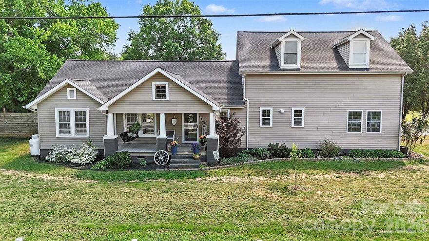 Beautiful farmhouse situated on a 1.6 acre corner lot completely updated top to bottom without losing its farmhouse charm. Extensive use of shiplap with light flooring and walls. Open floor plan boasts over 3,600 sq ft consisting of 6 bedrooms, 4.5 bathrooms! Outside there are 2 covered porches; an in-ground pool; a pool house w/bathroom; storage buildings; a gigantic 800 sq ft attached garage! AND a 2,400 sq ft detached workshop w/3 bay roll-up doors and office space, perfect for RV storing, hobbies, auto collection, workshop, or whatever you can imagine. The chef-worthy kitchen is a masterpiece with custom cabinetry w/pull-outs; beautiful quartz countertops; center island with butcher block top providing added workspace; an island with seating for entertaining; big farmhouse sink; walk-in pantry w/built-in cabinetry and wood countertops; and the charming pine beadboard ceilng is the 'frosting on the cake' in this beautiful kitchen. The Great Room/Dining Room with its soaring vaulted ceiling is anchored by a cozy fireplace and custom built-ins offering the perfect setting for gatherings and making memories. Library/office/den room with wall of built-in shelves/cabinets. The main floor bedroom wing has a full bathroom, an additional attached room for possible office or den with a full loft above, perfect for second living quarters. There's a mudroom w/built-in floor to ceiling shoe rack. Main floor laundry room with cabinets, built-in sink and folding table. Upstairs you'll find room for everyone with a loft gathering area, 5 bedrooms and 3 full bathrooms! The primary bedroom has a newly remodeled bathroom with a slipper tub, walk-in shower and dual vanities. Down the hallway you'll come to 4 additional bedrooms, one with an en-suite full bathroom, and at the end of the hall another full bathroom. Going through the French doors to the rear yard you can relax under the large covered porch or swim in the beautiful in-ground large rectangle swimming pool. All of the equipment, including the well equip is safely housed in the 'pool house' safe from weather deterioration. If your inner farmer is what calls you to this property you'll find plenty of space for raising chickens, goats, or growing your own food. You'll enjoy room to spread out with the zoning being a minimum of 3/4 acres in this area of Iron Station. A rural property that is only minutes from shopping, restaurants and schools. Charlotte is a quick drive down Hwy 16. Low Lincoln County property taxes. There's a small triangle parcel of 0.09 acres included  so there are two parcels in this sale totaling 1.6 acres.