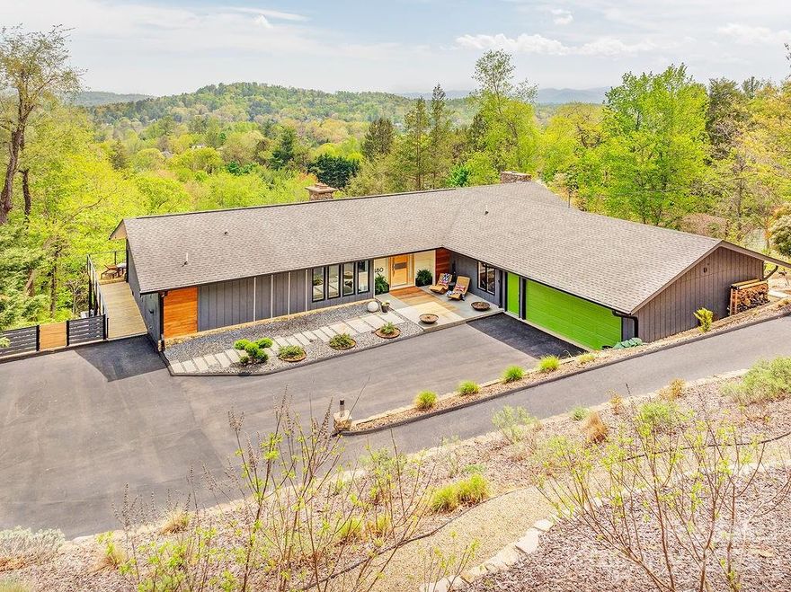 This stunning modern masterpiece in Lakeview Park will take your breath away. Relax in your outdoor paradise on the expansive Brazilian hardwood deck w/ year-round panoramic views, hardscaped lower level patio w/ swinging beds & bocce ball court. Let the sunset colors cast their spell on your evenings while the sunrise & Smokey Mountain clouds rise over your distant views of Downtown Asheville. This is mountain living at its finest w/ a bright & flowing, “just open enough” floor plan w/ vaulted ceilings, a sunken living rm w/ stone FP & Italian porcelain floors. So many custom details throughout. Open kitchen & dining area w/ a 14 ft book-matched leathered granite kitchen island w/ waterfall ends & a wall of sliding glass doors that flow to the outdoor living area. Main level offers 
 3bds/3baths, oversized 2-car garage & lower level w/ 2 bds/1 bath, family rm, office, exercise studio. A true showstopper w/ natural light & views at every turn! See add. features in MLS.