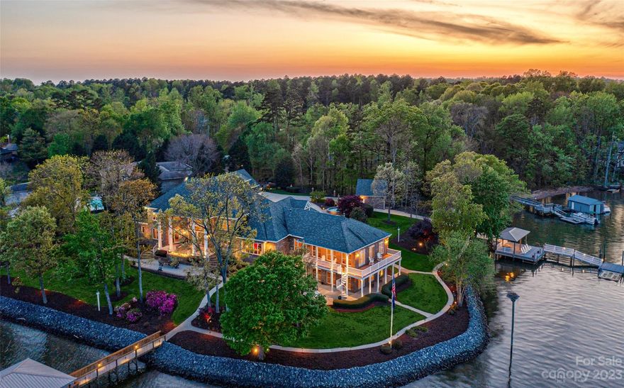 Extraordinary lakefront estate situated on 1.21 acres w/~600 feet of waterfront w/ breathtaking expansive channel views. Beyond the gated entrance, a bronze fountain, gently sloped lawns, and mature trees welcome you home. A boat ramp, 2 docks, 3 boat lifts, and 8 garages complete the scene. This estate boasts over 10,000 SqFt of living space w/ only the finest materials and top-of-the-line home automation and electronics. The great sun-drenched room presents stunning views through a two-story wall of windows. The wine cellar has stained glass windows and ample storage for the avid collector. Gourmet kitchen w/ Wolf cooktop, double prep island, Sub-zero fridge. Luxurious Primary suite on the main. Luxe billiard &amp; exercise rooms. Main floor Guest suite w/ 2-sided fireplace. Upstairs: 3 beds, 2 baths, cedar closet &amp; media room w/ 4K/Dolby. The lower level bar and rec room is the entertaining area—1,200 SqFt separate living quarters/apartment with private entry.