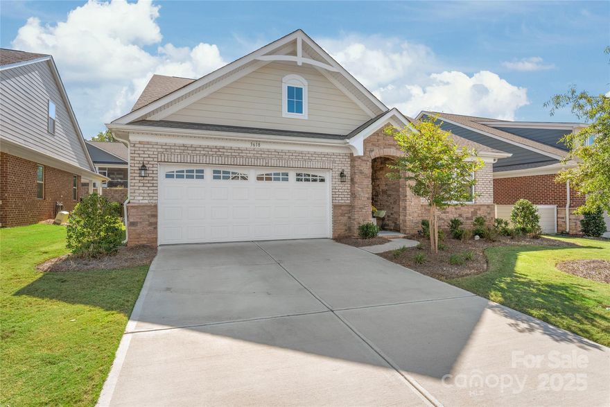 Welcome home to 3618 Marchers Trace Way, a beautifully designed, exceptionally bright and cheery 3 bedroom, 3.5 bath home offering the perfect blend of style, comfort, and low-maintenance living. Built by Mattamy and impeccably maintained, this like-new brick, stone, and fiber-cement residence delivers a lifestyle often found in 55+ communities, without age restrictions, just minutes from Mint Hill, I-485, dining, shopping, and all Charlotte has to offer. A welcoming covered front entry set the tone, with luxury vinyl plank flooring, elegant wainscoting, and thoughtful details throughout. Just off the foyer is a private main-level guest suite with ensuite bath, ideal for multi-generational living, featuring crown molding, vinyl plank flooring, and a tub/shower combo. Down the main hall, impressive double barn doors open to a flexible office or bonus space complete with crown molding and a built-in nook, perfect for a desk. The heart of the home unfolds into an open living, dining, and kitchen area designed for connection and conversation. The kitchen shines with quartz countertops, tile backsplash, stainless steel appliances, gas cooktop with hood, wall oven, pendant lighting, and a large island with seating for four. A huge walk-in pantry provides exceptional storage, while the gas log fireplace anchors the living space. Windows and oversized glass doors flood the home with natural light and lead to the screened-in patio overlooking the backyard. Tucked privately on the opposite side of the main level, the primary suite offers a peaceful retreat with tray ceiling, crown molding, and vinyl plank flooring. The spa-inspired bath features dual sinks, white countertops, and an oversized tiled walk in shower with both standard and rain shower heads, plus a generous walk-in closet. A main-floor laundry room and guest half bath add everyday convenience, with direct access to the finished two-car garage complete with utility sink. Upstairs, a private guest suite awaits with a spacious loft, full bath, and bedroom with walk-in closet, perfect for visitors or extended stays. Outside, enjoy a screened patio with ceiling fan and gas grill hookup, a block retaining wall, and peace of mind with a termite bond in place. The amenity-rich community includes lawn care, sidewalks, streetlights, dog park, pool, pickleball courts, clubhouse, pocket parks, and walking trails. Stylish, functional, and thoughtfully designed—this home truly checks every box.