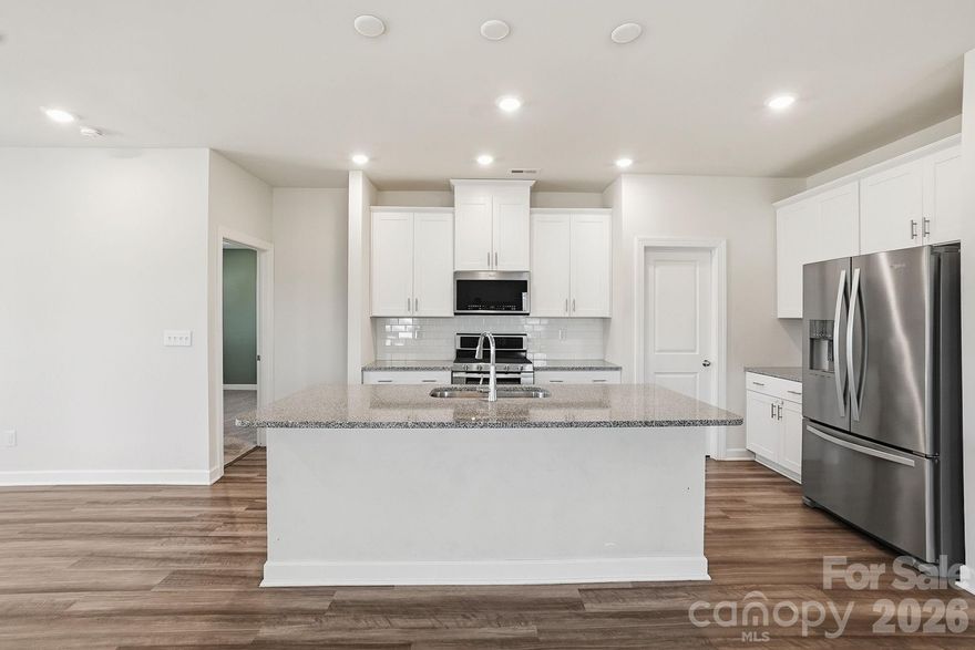 MOTIVATED SELLER...Stunning newer Craftsman-style residence offering refined one-level living with over 1,650 square feet of beautifully designed space. This 3-bedroom, 2-bath home showcases an oversized great room filled with abundant natural light, creating an inviting yet sophisticated atmosphere. The gourmet kitchen anchors the home and opens seamlessly to a spacious dining area—perfect for both elegant entertaining and everyday comfort. Retreat to the serene primary suite, while two additional bedrooms provide flexibility for guests or a home office. Enjoy the convenience of a 2-car attached garage and unwind on the covered outdoor porch overlooking a fully fenced yard. A rare blend of craftsmanship, comfort, and upscale living.