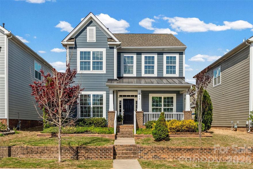 Ideally located in the heart of Tega Cay and just minutes from Fort Mill, this beautiful home offers access to top-rated schools and the benefit of low South Carolina taxes. Enjoy close proximity to I-77, dining, shopping, and entertainment. All while being tucked away on a desirable street in the center of the neighborhood, just a short walk to the community pool. Designed for both everyday living and entertaining, the kitchen features a large island with built-ins, abundant cabinetry, granite countertops, stainless steel appliances, ceramic-top range, and a butler’s pantry. Kitchen is open to the breakfast area and family room. Natural light fills the home throughout. The main-level study is enhanced with French doors and custom built-in cabinetry, creating the perfect private workspace.
The spacious primary suite offers a tray ceiling and a beautifully newly renovated spa-like bath, complete with an enlarged shower and custom wood vanity. Upstairs, you’ll find two additional bedrooms, brand-new carpet throughout the entire upper level, and a generous loft area that can easily be converted into a fourth bedroom.
Step outside to your own private retreat. The fenced backyard features retaining walls, a gorgeous patio ideal for entertaining, and professional outdoor lighting with a timer that enhances the ambiance and creates a true courtyard feel with wonderful afternoon shade. The detached, oversized 22’ x 24’ rear-load two-car garage provides ample space for vehicles and storage. Great Location and Beautiful Home!!! Floors newly refinished!