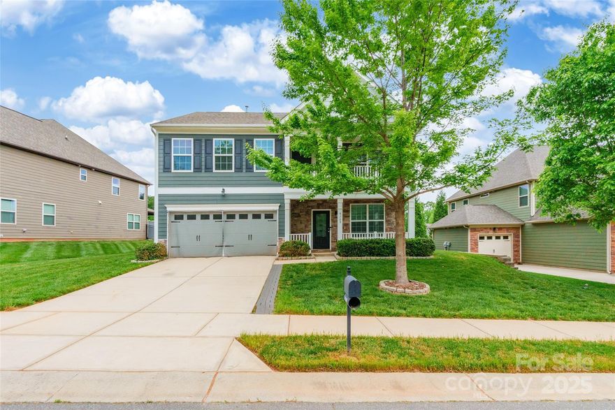 The Wilmington Eastwood floor plan is as impressive on the outside as it is spacious on the inside. Set on a private, wooded lot, this home features both upper & lower-level front covered porches that add charm & character to its exterior. Inside, the thoughtful layout offers hardwood floors throughout the main level and a spacious great room with a gas log fireplace. The kitchen is equipped with granite countertops, an island, stainless steel appliances & a pantry. The formal dining room stands out with elegant wainscoting & tray ceilings. Upstairs, you’ll find all bedrooms & a versatile loft area. The primary suite features tray ceilings, a walk-in closet, an ensuite bathroom with a garden tub & dual vanity, and direct access to the upper-level porch. Conveniently located near Lake Wylie, shopping, dining, I-485, and the airport. The community features amenities including a pool, clubhouse, tennis courts, playground & more, offering a fantastic environment just outside your door!