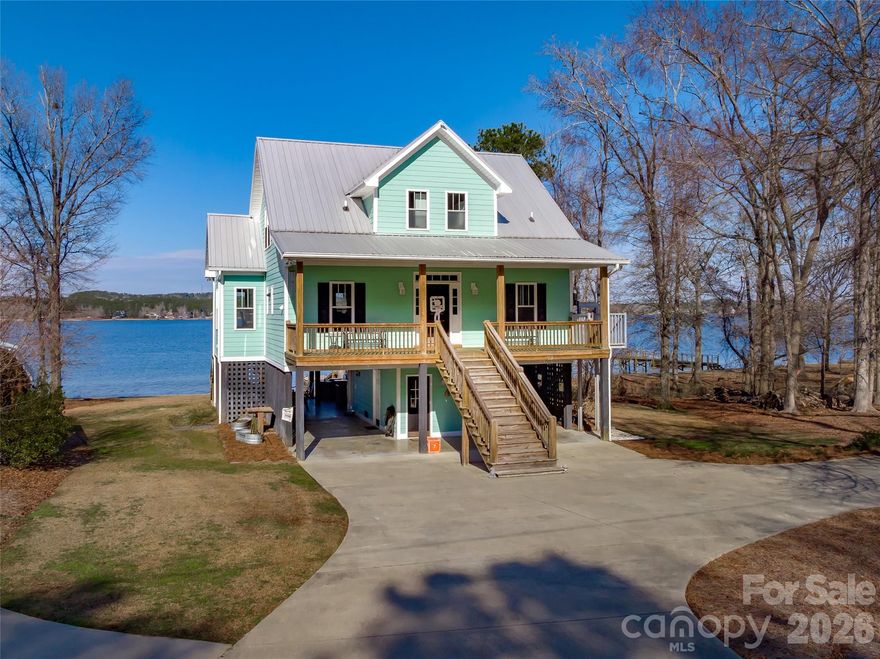 Where's the party at? If you want to be the place to be this summer, look no further. This home was set up with hosting and entertaining in mind! Stunning main channel views from every room of this beautiful home built in 2015. Gorgeous hardwood floors, ceramic tile and granite throughout, a walk in tile steam shower and his and hers closets in the primary on the main level and a smart second living area with guest rooms upstairs. But the thing that you'll love most other than the fantastic lake views is the party pad underneath. Constructed with stone and granite and stainless steel appliances, this bar and full kitchen with seating and mounted TV's all around is calling your name this summer! There is a 3rd full bath down here also and a convenient storage area for the lake toys. Relax on the firepit deck or take a short, easy walk down to the dock. Need a place for swimmers? This one has that too! And did I mention it has a convenient lift from the parking area up to the main floor? Yep. They thought of everything. Literally the perfect lake house for weekends or full timers!