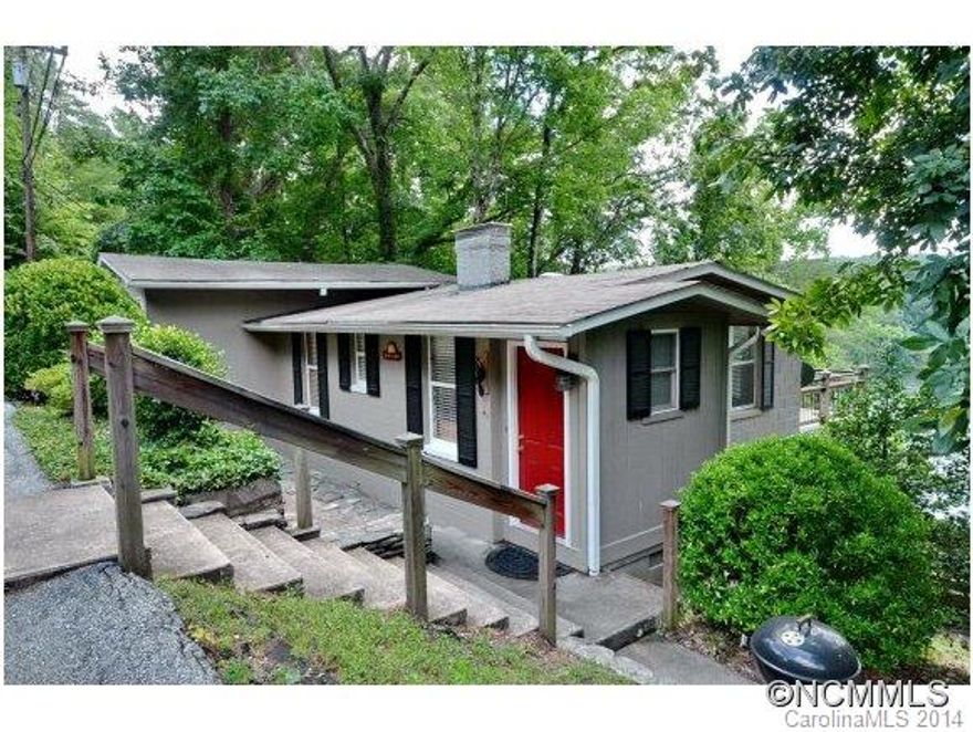 Perfect Vacation Cottage at Lake Lanier. Breathtaking mountain & lake views! Charming interior recently remodeled. Main level includes full kitchen, living room w/old brick fireplace & hardwood floors, bunk room & half bath. Lower level master bedroom w/sitting area and full bath. Nice decks on both levels to enjoy the views. Double garage & unfinished bsmt area w/laundry.  Also included is boat house w/dock & boat lift. Most furniture conveys