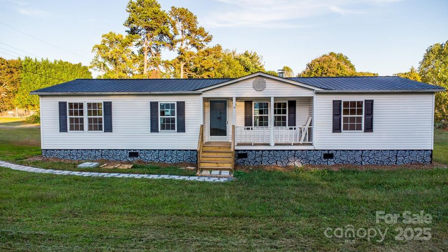 Now offered at a low price of $199,000, this refreshed home at 2918 23rd Ave NE presents a strong value for buyers seeking flexibility, privacy, and convenience. Seller financing is available at $210,000, with limited conventional loan options also available for qualified buyers.

Neatly tucked away yet just minutes from downtown Hickory, the property is situated on approximately half an acre, the outdoor space includes a covered front porch and two brand-new rear decks—perfect for relaxing, hosting, or enjoying peaceful green views. While discreetly positioned behind nearby businesses, the setting feels private and serene, with quick access to major highways, shopping, dining, and daily amenities.

The interior features a bright open-concept layout with brand-new luxury vinyl plank flooring, fresh neutral paint, and abundant natural light. The spacious living room is centered around a stone-accented fireplace, creating a warm and inviting focal point.

A split-bedroom floor plan enhances privacy, with the primary suite separated from the secondary bedrooms. The primary retreat offers a walk-in closet and an ensuite bath with dual-sink vanity and a soaking tub. Two additional bedrooms and a full bath provide versatility for guests, home office use, or additional living needs.

Due to the home’s manufactured status, traditional financing options are limited. Ideal for buyers with substantial cash reserves. Seller financing available for qualified buyers only.