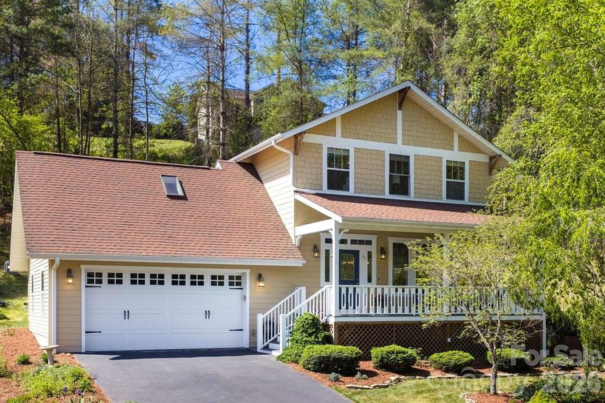 Tucked away in Brigadoon Estates, this inviting Weaverville home offers a peaceful neighborhood setting surrounded by trees, rolling hills, landscaped gardens, and abundant wildlife. Outdoor living is easy with both a covered front porch and rear deck overlooking the hillside. A brand-new roof, low-maintenance fiber cement exterior, attached two-car garage, newer heat pump and water heater, add to the move-in-ready appeal. The certified wildlife habitat, blue jays nesting in the front porch eaves, and natural surroundings make it easy to slow down and enjoy the peaceful setting.
The main level features a bright, open floor plan with wood floors, and oversized windows. The living room is anchored by a gas fireplace, while the dining area includes a built-in hutch and access to the newly built back deck. The kitchen offers fresh, bright finishes with white cabinetry, quartz countertops, pendant lighting, newer stainless steel appliances, a tile backsplash, a peninsula with storage, and a conveniently located pantry and laundry closet.
Upstairs, the primary suite includes an ensuite bath with a soaking tub, separate walk-in double shower, and updated vanity. Two additional bedrooms and a full guest bathroom complete the upper level. A spacious bonus room over the garage provides valuable flex space for a home office, creative studio, media room, or playroom. All within easy access to Weaverville and Asheville.