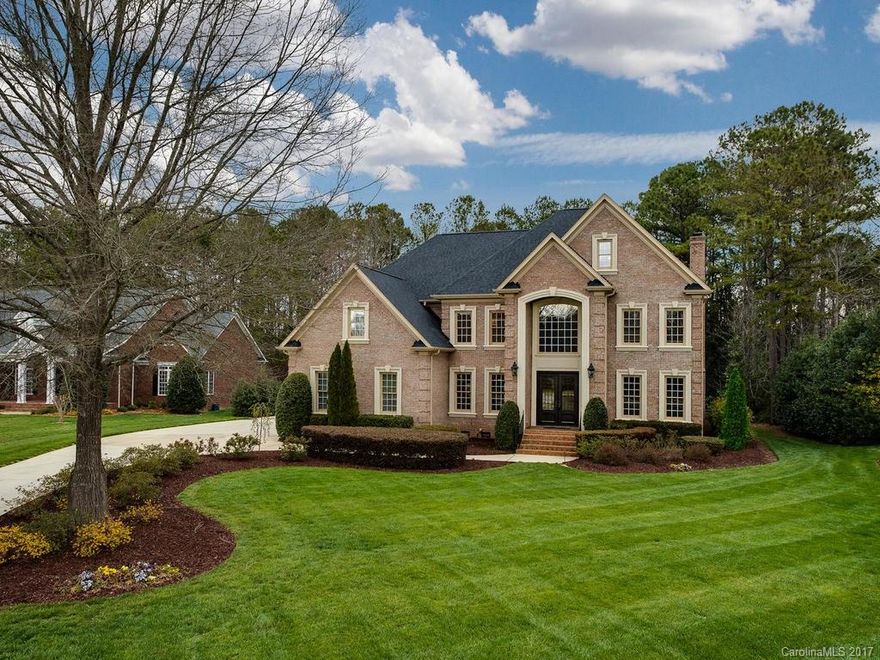 Immaculate custom brick 2.5 story in popular Providence Downs.  Strong schools w/low Union County taxes. Gourmet kitchen w/custom cabinets, granite, SS appliances, prep island w/bar seating, gas cooktop, dbl ovens. 10’ ceilings down, 9’ up. Guest suite on main. Large sun porch overlooks travertine tile patio, fire pit & outdoor kitchen. Beautiful woodwork, hardwood floors & heavy moldings. Fenced rear yard. Two oversized 2-car Garages, one attached, one detached w/finished area above. Stunning!