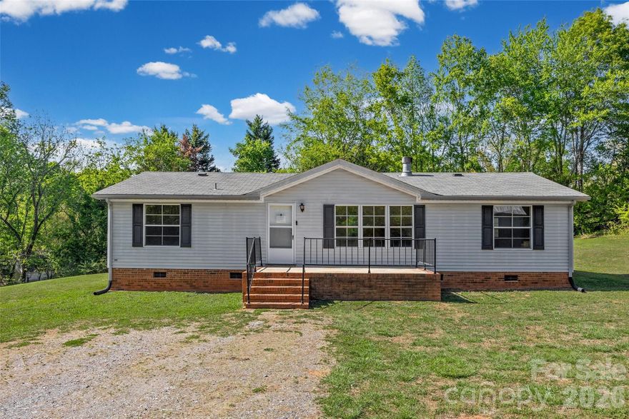Enjoy the space and privacy of 5 beautiful acres in desirable Clover, where this 3-bedroom, 2-bath home offers a relaxed and comfortable setting within the award-winning Clover School District.
The interior features a functional layout with spacious bedrooms, recently refreshed with new luxury vinyl plank flooring, a freshly painted interior, and a renovated guest bathroom. A cozy wood-burning fireplace creates an inviting focal point in the main living area.

Step outside and take in the peaceful surroundings, perfect for morning coffee, outdoor exploring, or simply unwinding at the end of the day. With a blend of open space and everyday convenience, this property offers a great opportunity to enjoy quiet living without feeling far from it all.

Bollinger Pond Dr is a private road with a 130 ft drive right-of-way, see attached plat.