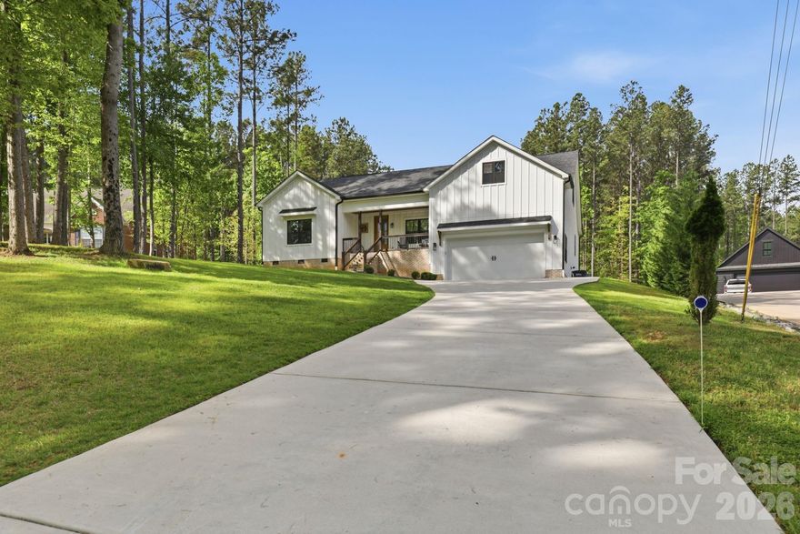 Welcome to this stunning, modern farmhouse-style 1.5-story home where charm, space, and serene water views come together beautifully. Nestled on over an acre, this thoughtfully designed 4-bedroom, 3.5-bath home offers the perfect blend of modern comfort and timeless appeal.
Enjoy your morning coffee on the covered front porch with peaceful water views, or unwind in tranquil settings on the covered back deck. Inside, this spacious home features an open-concept floor plan ideal for both everyday living and entertaining. The inviting living area showcases an electric fireplace, while the kitchen is sure to impress with a large island, quartz countertops, a brick backsplash, soft-close cabinetry, abundant cabinet space, and a well-appointed scullery for added prep space and storage.
The main-level primary suite is a true retreat, offering a generously sized bedroom, a spa like bathroom, and direct access to the covered back deck perfect for relaxing in privacy. Also on the main level are two secondary bedrooms with a shared full bathroom, ideal for family or guests. Upstairs, you’ll find a private guest bedroom complete with its own full bathroom and walk-in attic storage perfect for visitors, or additional flex space. Every bedroom in the home features a walk-in closet, providing ample storage and functionality throughout.
The home features durable luxury laminate flooring throughout the main living areas and beautifully tiled bathrooms, combining style with low-maintenance living.
Water views can also be enjoyed from the front bedroom, adding to the home’s charm. Located just minutes from the state park, this property offers the ideal blend of privacy and convenience. A 2-car garage, potential for car lift with the soaring 15ft ceiling and expansive lot provide ample room for storage, outdoor living, and future possibilities.
If you’ve been searching for a beautifully maintained, one-owner farmhouse-style home with space, style, and scenic views—this one checks all the boxes.