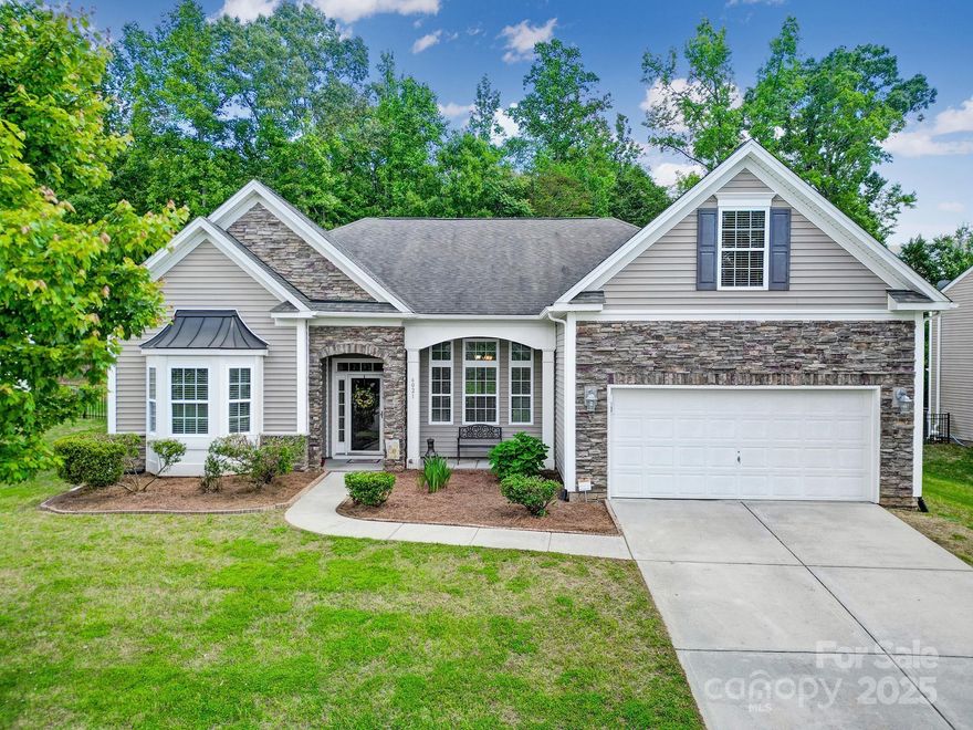 Don't miss out on this beautiful move-in-ready home in the highly desired Woodlands subdivision. Newly updated with fresh paint, new LVP flooring, new carpet, & the HVAC unit is only 5 years old. Open concept living with high ceilings giving this home a spacious feel while still keeping it cozy with 3 bedrooms & 2 full bathrooms on the main level including the primary suite. Upstairs you'll find one more bedroom over the finished garage. Easy to grill out and entertain with the kitchen leading to the fully fenced in backyard. Take advantage of the 16'x12' covered patio mirrored by an additional uncovered 16'x12' patio for those rainy and sunny days. Community amenities include an in-ground pool, clubhouse, playground, picnic area, street lights & sidewalks. Close to retail, restaurants, and school and easy access to I-77.