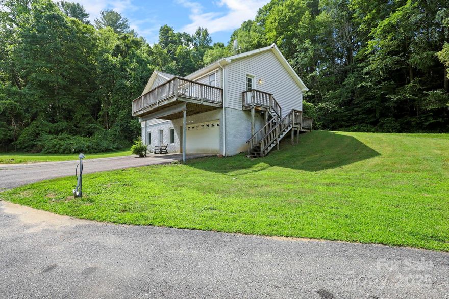 Nestled on approximately 2.6 peaceful acres with creek frontage and a small pond, this charming home offers a rare opportunity to create your own private mountain retreat. Set back from the road in a super quiet and serene setting, the property features 2 bedrooms and a versatile flex room that's perfect for a home office, study, or guest space. Much of the home remains in its original condition, giving buyers the chance to update and personalize it to their taste while preserving its comfortable, livable layout. This home offers tons of livable space!

The main level includes a spacious living area, an eat-in kitchen and bedrooms positioned for privacy. Downstairs, the basement level offers valuable additional living and utility space, including a large den, full bathroom, garage/workshop area, and a storage area—ideal for hobbies, tools, or outdoor gear. The garage space provides convenient parking or could easily serve as a handyman’s workshop or creative studio. Check out the floorplan for more details!

Located just a few miles from Roan Mountain, TN, and a short drive to Roan Mountain State Park, you’ll have easy access to hiking, waterfalls, and breathtaking high-elevation views along the Appalachian Trail. The home is also within 30 minutes of Beech Mountain and Sugar Mountain ski resorts, offering year-round outdoor recreation from skiing and snowboarding to mountain biking and festivals.

Whether you’re looking for a peaceful family home, a vacation getaway, or a short-term rental close to some of the region’s most popular attractions, this property offers endless potential in a serene mountain setting.