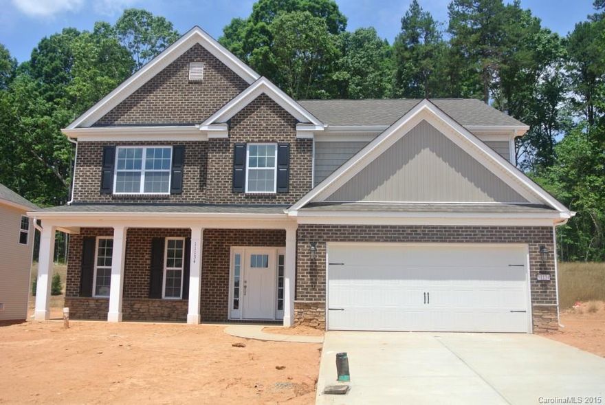 Brick front with rocking chair front porch! Dramatic 2 story entry, hardwood foyer, dining, kitchen, breakfast and family room stone fireplace in family room. Gourmet kitchen with Kona staggered cabinets with pullouts, stainless, built in wall ovens, gas cooktop, Venetian Ice granite counters and beautiful backsplash!  Granite in all full baths, tile in all wet areas, tile surround in master tub and shower area!