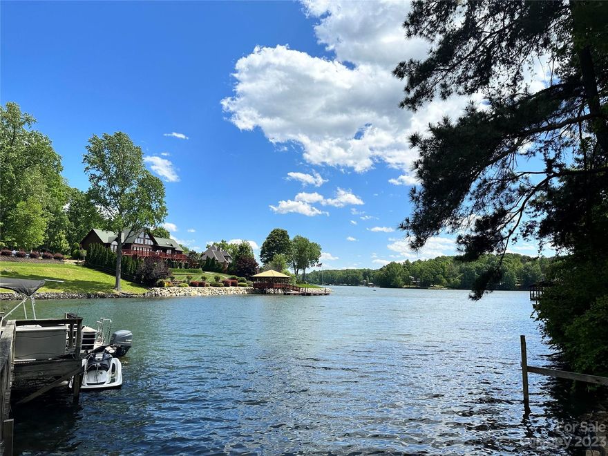 LAKE NORMAN WATERFRONT LISTED $100K UNDER NEW TAX ASSESSMENT! Beautiful 2016 Farmhouse style interior mobile home with 4 bedrooms (3 bedroom septic) and 2 bathrooms with a split bedroom floorplan with both a living room and a family room.  The acreage is .75  and located in the HOT school district of Lake Norman High, Lakeshore Middle and Lakeshore Elementary Schools!  Surrounded by beautiful CUSTOM homes for a potential future new build, this lot has 187 feet of shoreline, DEEP water and lovely lake views!  Would also make a lucrative VACATION RENTAL after dock remediation.  NO HOAS and low Iredell county taxes (only) make this lake living stress and care free!