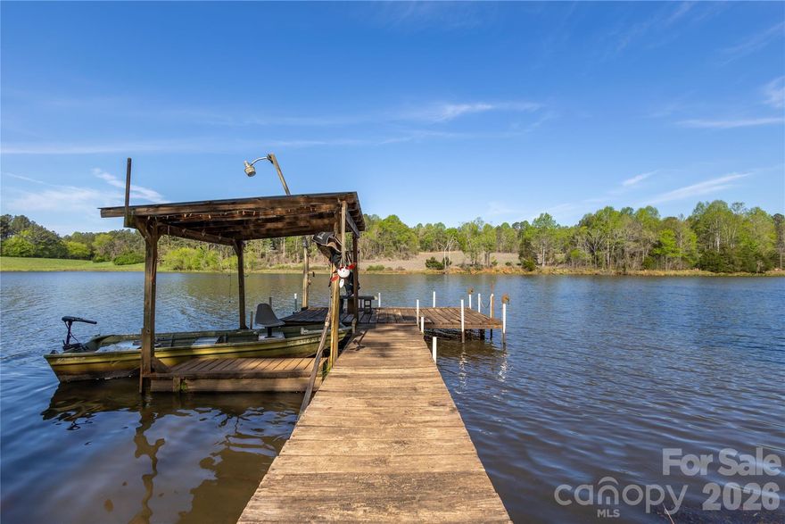 1.99+/- Lakefront Acres! Tucked away in the rolling farmland of Union Mills, NC this rare lakefront property offers the kind of setting people often spend years searching for. Featuring a 3-bedroom, 2-bath mobile home with huge covered deck, this property is already equipped with power, well, and septic system—making it ready for immediate enjoyment as it is or get's you a head start on future building plans. Wake up to calm water views and unwind each evening with your own private lake frontage just steps from your back door. A deeded right-of-way along a short gravel road provides easy access, while the privacy and serenity of the surrounding wooded property gives you the quiet, "miles away from it all" feeling that’s getting harder and harder to find. The excellent location seals the deal... just 15 minutes to the world-class Tryon International Equestrian Center, 30 minutes to Hendersonville, and under an hour to Asheville makes for easy trips to enjoy dining, shopping, outdoor recreation and entertainment. Whether you’re looking for a full-time residence, a weekend escape, short term rental or investment opportunity, this property checks a lot of boxes that are hard to come by. Don't put it off, Summer is almost here and the fish are biting. Come and get it before someone else claims your spot on the lake.