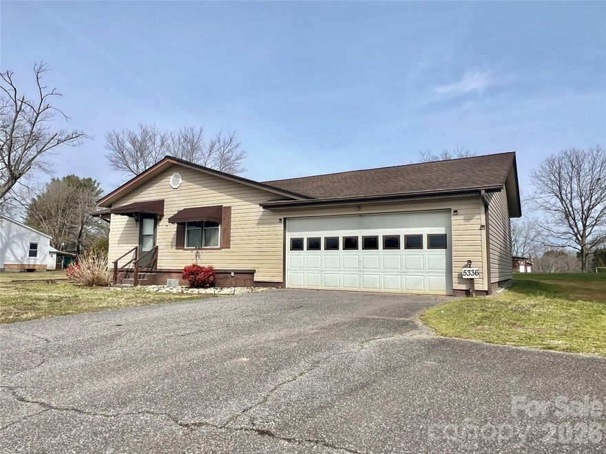 Nicely maintained older property featuring 3br/1ba, hardwood floors, dining room, laundry room, breakfast bar.  There is a room on the front of the property that could be used for multipurposes as it has a wall mount propane heater.  Attached double garage and also a workshop/garage/storage shop with over 1000sf of space. The house with approx 0.90 acres is being surveyed off the total 7 acres. We believe the house is older that what is on the tax card.