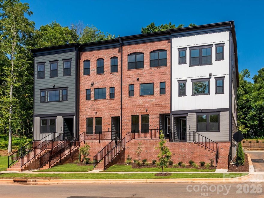 Welcome to 317 Old Town Village, a Price plan townhome tucked away in the charming, tree-lined community of Old Town Village in Waxhaw, NC. This stunning end-unit offers added windows throughout, flooding the home with natural light across all three levels. On the first floor, a fourth bedroom with a full bathroom features beautifully tiled walls in the walk-in shower, ideal for guests or multigenerational living. Oak box stairs with open rails carry through both the first and second floors, adding an elevated, airy feel. The second floor showcases a gourmet kitchen outfitted with white cabinets, white quartz countertops, a GE 36" gas cooktop, a large single bowl stainless steel sink with a Delta Essa Touch faucet, and a striking grey Mythology-Harmonia picket mosaic backsplash, all flowing seamlessly to a covered outdoor living space. The Convenience Package adds thoughtful touches like double roll trays and base waste basket for effortless daily organization in the kitchen. On the third floor, the primary en suite impresses with rich grey cabinets, white quartz countertops, and a beautifully tiled walk-in shower. A 2-bay tandem garage rounds out this exceptional home. With access to historic downtown Waxhaw's local shops and dining, 317 Old Town Village offers the perfect balance of privacy, charm, and modern living. Schedule your tour today.