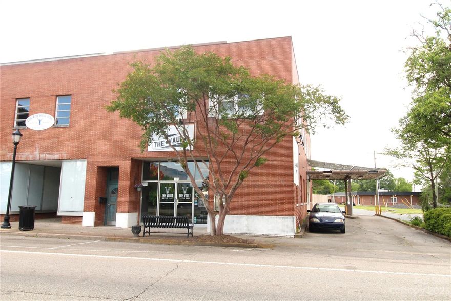 Brick, 2 Story, Building Located in the Central Business District of Clover with approximately 2683 Sq ft on the main floor and 2 Apartments upstairs. The main floor features and open area as well as 2 offices, work room, bathroom and an older bank vault.   Apartment A has  approximately 753 SQFT with 2 Bedrooms and 1.5 Bathrooms. Apartment B has approximately 1053 SQFT with 2 Bedrooms and 1 Bathroom. Upstairs Apartments are heated by Gas. There is also approximately 500 SQFT storage area upstairs that could possibly expanded for additional rental space. Both apartments and commercial/retail space is currently rented. Note pictures from Apartment were taken before tenant move in and were submitted by the owner.