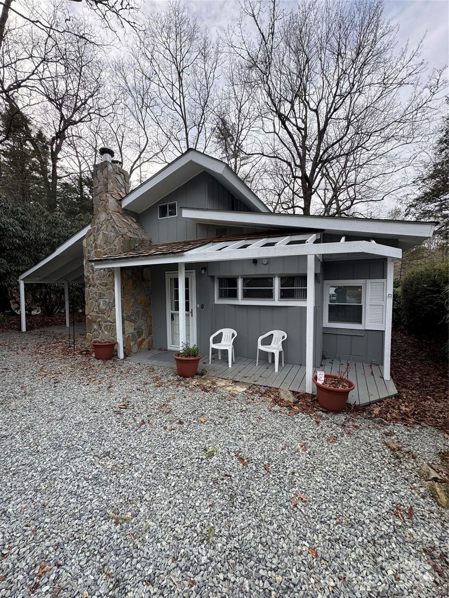 Pulling into the Driveway you notice the beautiful stone chimney. From the moment you walk through the front door, you will appreciate the care and attention to detail in this charming two-bedroom, one-and-a-half-bath Land Harbor cottage. The original RV park model has been completely remodeled to include a half bath, a laundry area, and a primary bedroom. The updated kitchen is sure to impress with updated appliances coffee bar, and generous pantry storage. Here you also find the dining area. The large living room offers the option to reinstall a wood-burning stove or gas fireplace kit; the flue is still intact. The current propane heater now provides comfort on chilly evenings, giving ambiance of a cozy fire. Multiple skylights brighten the home with abundant natural light. The guest bedroom features ample windows and a Murphy bed that conveniently tucks away, if needed. You’ll appreciate the original hardwood floors in this part of the home, and the owner notes that the same flooring continues beneath the carpet in the living room. Luxury vinyl plank flooring has been added to the remodeled areas. The full bathroom includes a stand-up shower, granite countertops, and plenty of storage, including a utility closet. Upstairs, you’ll find a large attic space with windows and an area that could potentially be converted into additional space with a bit of creativity. Built-ins throughout the home add to its charm, making this Land Harbor property a must-see. Outside, you will find a covered patio/carport area with walk around decking leading to an open entertaining back deck. Ample parking is also provided at this home. Location is within walking distance to the Golf House and Patio Grill. POA dues include swimming pool, water, sewer, cable tv, internet, 24/7 security, trash collection and road maintenance. SOLD Completely Furnished!