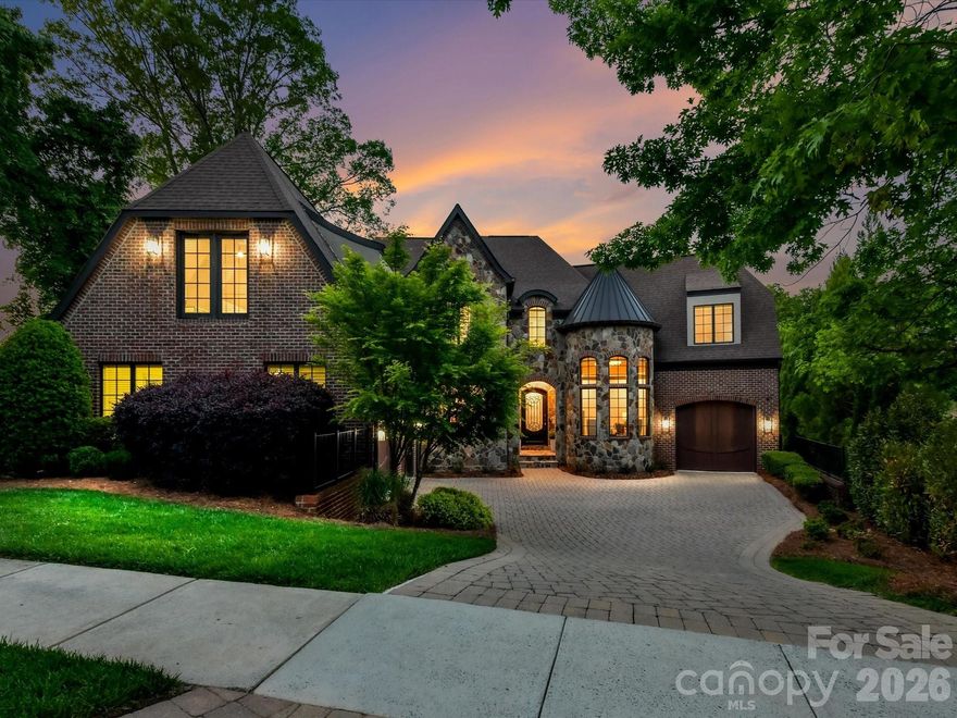 Reminiscent of a romantic Italian villa, this custom brick and stone residence delivers 7000+ square feet of elegant resort-like living…in South Charlotte’s exclusive enclave of Chambery. Enjoy expansive pond views in a private park-like setting. Clark and Hall’s custom Tuscan-style iron and glass front door invites you into 3 levels of meticulously designed living spaces that include 6 bedroom en-suites, a powder room, multiple main level offices, bonus rooms, and flex rooms galore. Oversized casement windows. Arched doorways.  Dramatic ceilings throughout: vaulted, tray, cathedral, coffered and turret ranging from 9.5 to 16 feet in height.  Hardwood floors throughout much of the main and upper levels. Formal living room with wood wall trim. Great room with fireplace. Gourmet chef’s kitchen features two functional islands, 48” gas range, pot-filler, and built-in refrigerator. Main level oversized primary bedroom suite boasts walk-in closet with new Stark carpet, dual vanities, spa-like bathroom with linen closet, soaking tub, glass shower, heated bathroom floors and private water closet. Two large bonus rooms flank the upstairs floor plan offering 3 generously-sized bedroom en-suites and loft space. One Upstairs Bonus Room functions as a private, undiscoverable safe room and cleverly closes with a custom bookshelf door. The Basement retreat offers 2 bedroom en-suites (one currently used as a home gym), a home theater/media room with tiered seating and projection screen, a 2nd kitchen, and a 500+ bottle humidity-controlled wine cellar, and an abundance of storage. Elevated rear loggia and majestic veranda overlook a heated pool with integrated spa: the perfect backdrop for casual gatherings or formal entertaining. Outdoor grill area. 2-car garage leads to interior drop zone with cabinetry. Dedicated 1-car garage is private and offers no access to interior (currently home to a golf simulator that does not convey). Conveniently located to SouthPark, Phillips Place, championship golf courses, greenways, fine dining and Charlotte Douglas International Airport.
